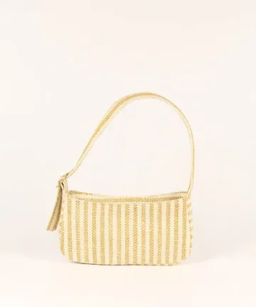 Product Description: GAIA – Organic Textured Jute Baguette Made out of artisanal handicraft jute fabric, this baguette is sturdy, simple yet has an earthy finish to it. Cotton lining inside, with adjustable straps by 3 knots. Color: Cream and Beige Stripes Length: 5.5 inches Width: 10 inches Height: 4 inches Price: ₹900/-