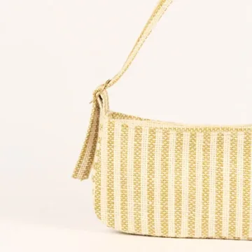Product Description: GAIA – Organic Textured Jute Baguette Made out of artisanal handicraft jute fabric, this baguette is sturdy, simple yet has an earthy finish to it. Cotton lining inside, with adjustable straps by 3 knots. Color: Cream and Beige Stripes Length: 5.5 inches Width: 10 inches Height: 4 inches Price: ₹900/-