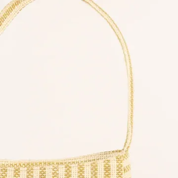 Product Description: GAIA – Organic Textured Jute Baguette Made out of artisanal handicraft jute fabric, this baguette is sturdy, simple yet has an earthy finish to it. Cotton lining inside, with adjustable straps by 3 knots. Color: Cream and Beige Stripes Length: 5.5 inches Width: 10 inches Height: 4 inches Price: ₹900/-