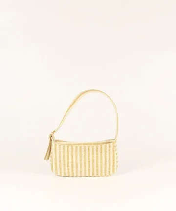 Product Description: GAIA – Organic Textured Jute Baguette Made out of artisanal handicraft jute fabric, this baguette is sturdy, simple yet has an earthy finish to it. Cotton lining inside, with adjustable straps by 3 knots. Color: Cream and Beige Stripes Length: 5.5 inches Width: 10 inches Height: 4 inches Price: ₹900/-