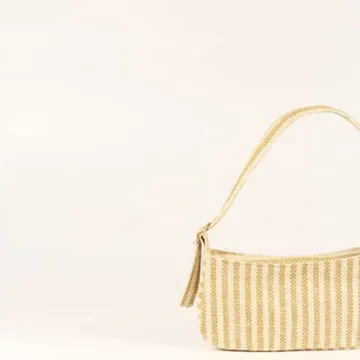 Product Description: GAIA – Organic Textured Jute Baguette Made out of artisanal handicraft jute fabric, this baguette is sturdy, simple yet has an earthy finish to it. Cotton lining inside, with adjustable straps by 3 knots. Color: Cream and Beige Stripes Length: 5.5 inches Width: 10 inches Height: 4 inches Price: ₹900/-