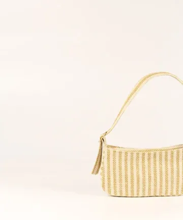 Product Description: GAIA – Organic Textured Jute Baguette Made out of artisanal handicraft jute fabric, this baguette is sturdy, simple yet has an earthy finish to it. Cotton lining inside, with adjustable straps by 3 knots. Color: Cream and Beige Stripes Length: 5.5 inches Width: 10 inches Height: 4 inches Price: ₹900/-