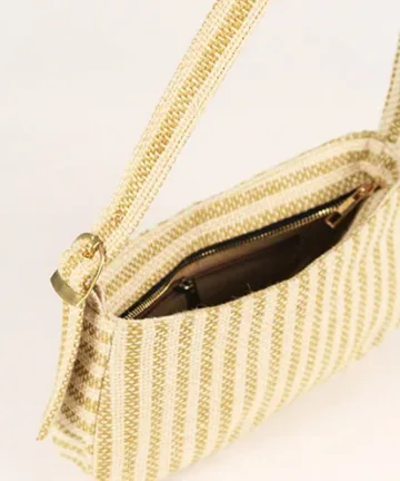 Product Description: GAIA – Organic Textured Jute Baguette Made out of artisanal handicraft jute fabric, this baguette is sturdy, simple yet has an earthy finish to it. Cotton lining inside, with adjustable straps by 3 knots. Color: Cream and Beige Stripes Length: 5.5 inches Width: 10 inches Height: 4 inches Price: ₹900/-